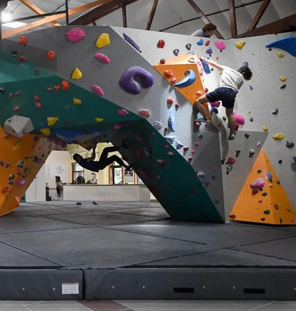 A bouldering wall with some climbers